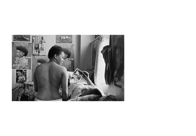 Woman sitting on her bed with a friend